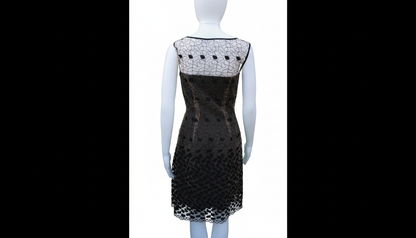 Black dress with white lace details on a mannequin against a white background
