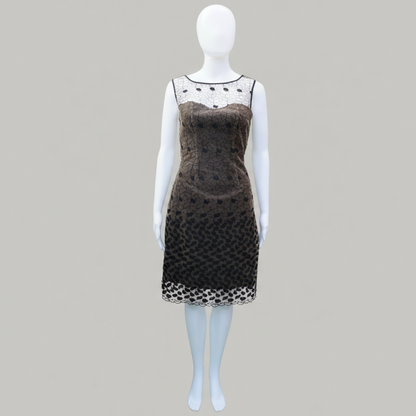 Mannequin wearing a black dress with white lace details on a gray background