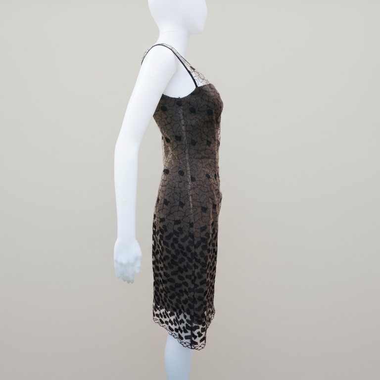 Mannequin wearing a brown dress with black pattern on a plain background