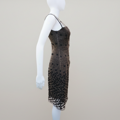 Mannequin wearing a brown dress with black pattern on a plain background