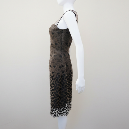 Mannequin wearing a leopard print dress on a plain background
